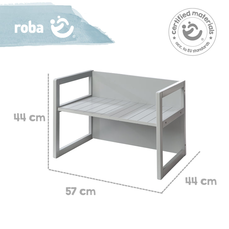 La panca rustica, grigia, può essere trasformata in 2 altezze di seduta o utilizzata come tavolino per bambini