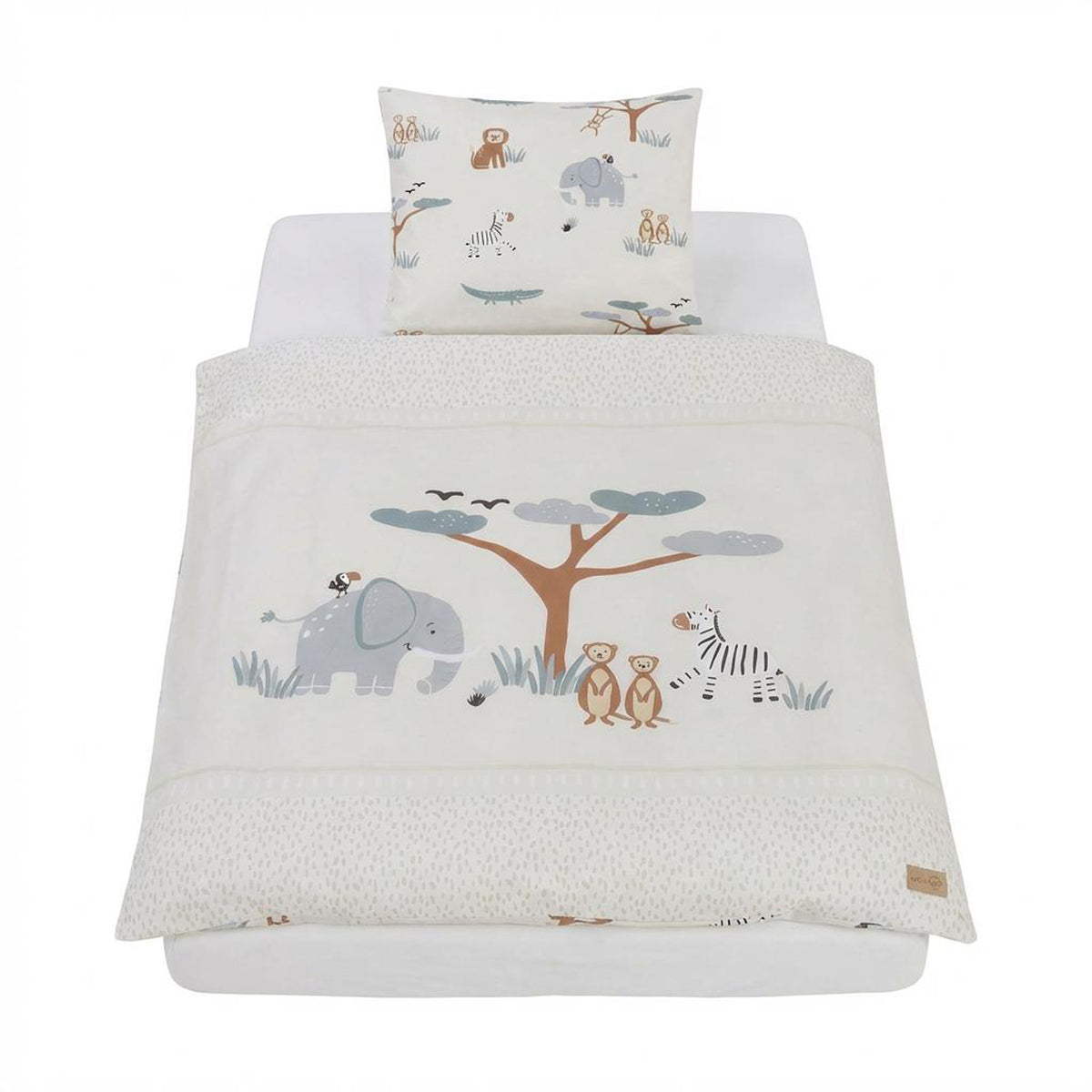 Cradle bedding "Savanna Friends" 2-piece, made up on the bed – pillowcase with colorful animal pattern and duvet cover with embroidered savanna scene featuring elephant, tree, zebra and meerkat