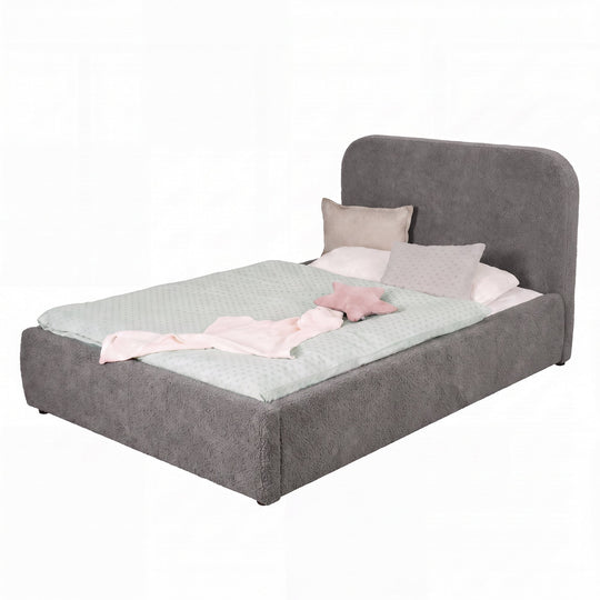 Lit gris en bouclé avec linge de lit rose, détouré sur fond blanc.