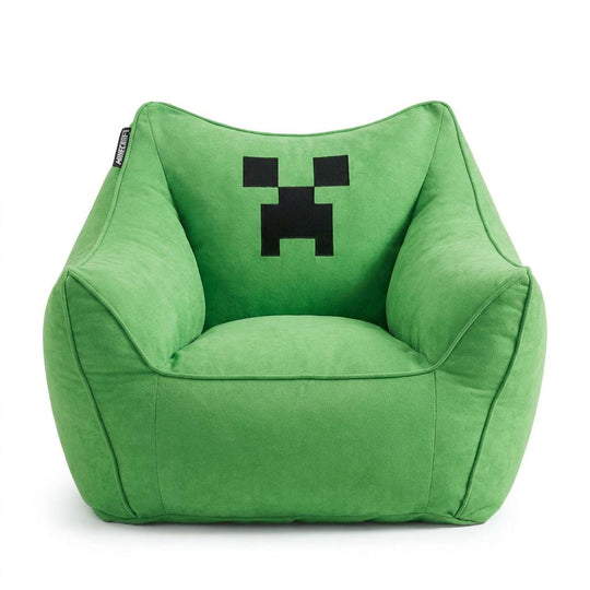 Sillón puf verde con reposabrazos y cara pixelada negra de Creeper bordada, vista frontal sobre fondo blanco.
