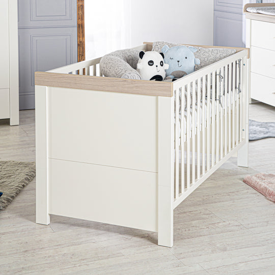 Cuna convertible 'Lucy' 70 x 140 cm, convertible, blanca, cornisa en 'Luna Elm'